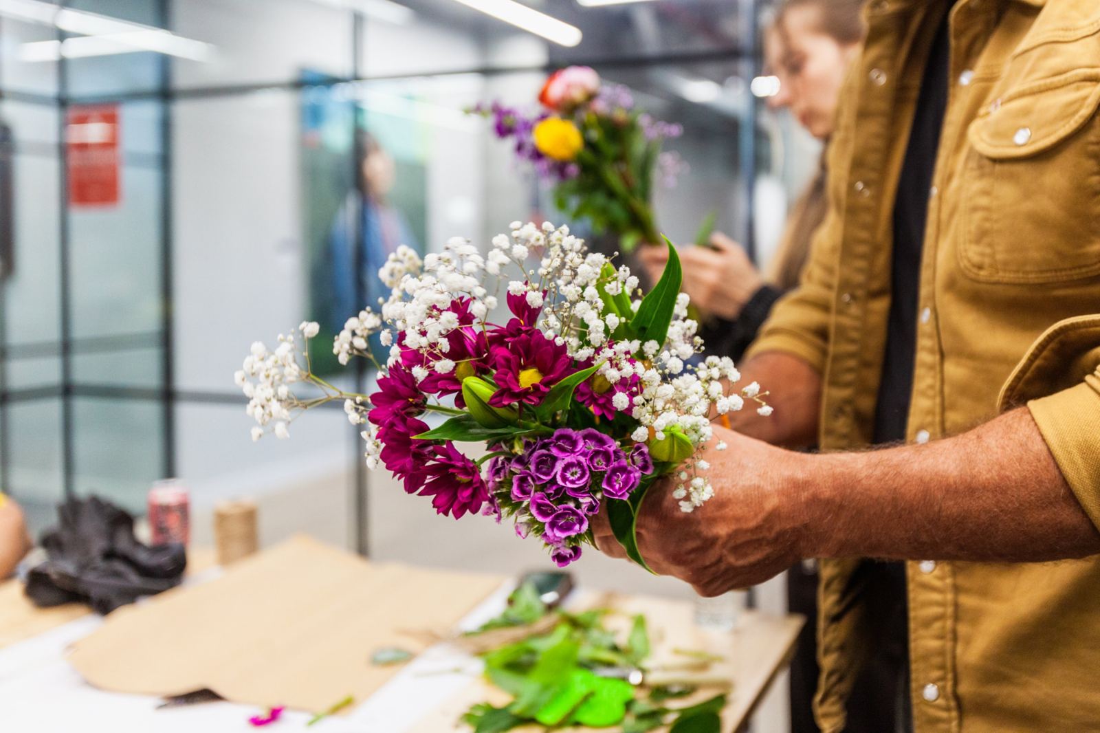 A hand-tied bouquet of gypsophila, magenta chrysanthemums and sweet williams